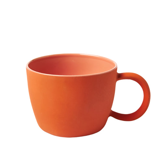 Orange mug on a white background