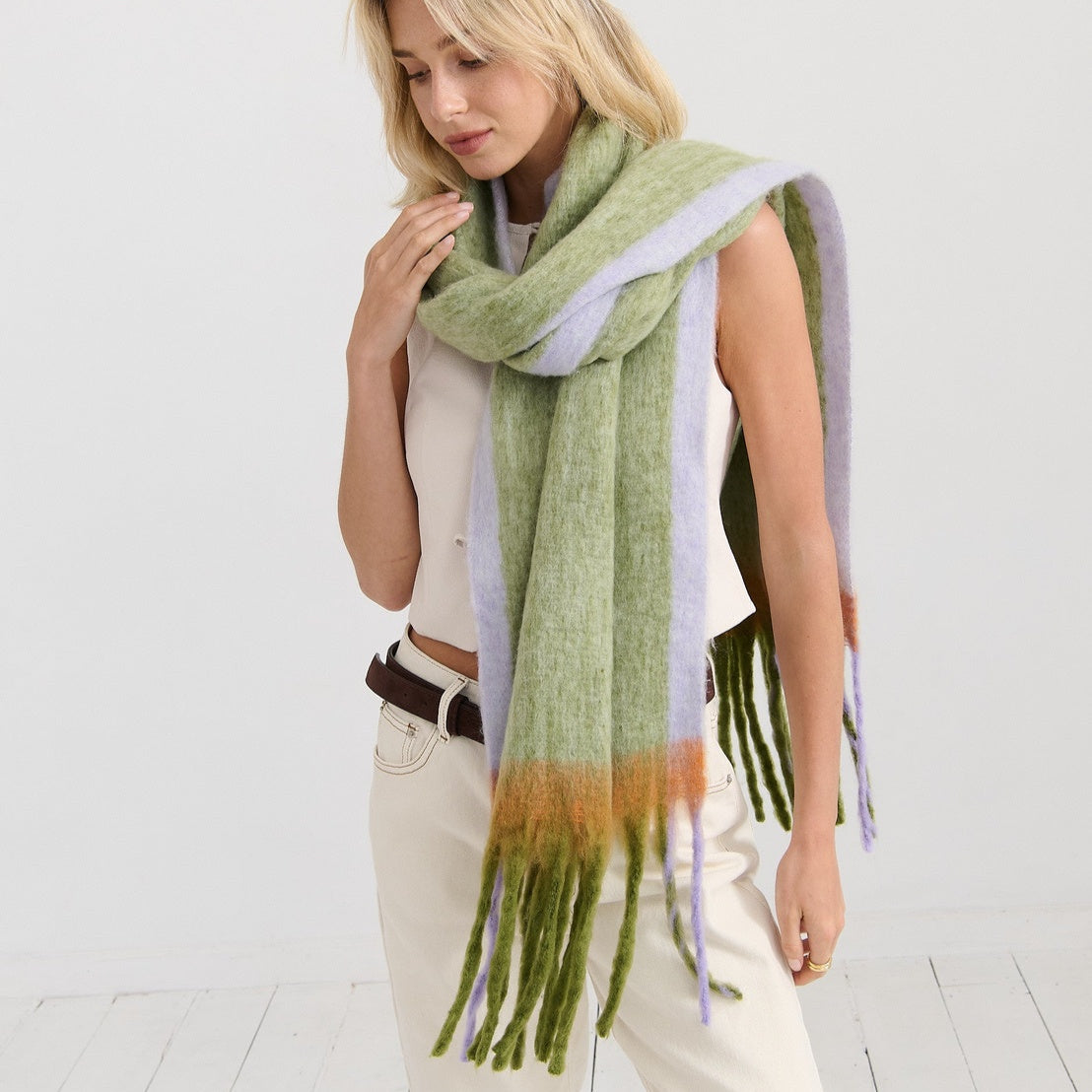 Woman wearing a green and purple scarf