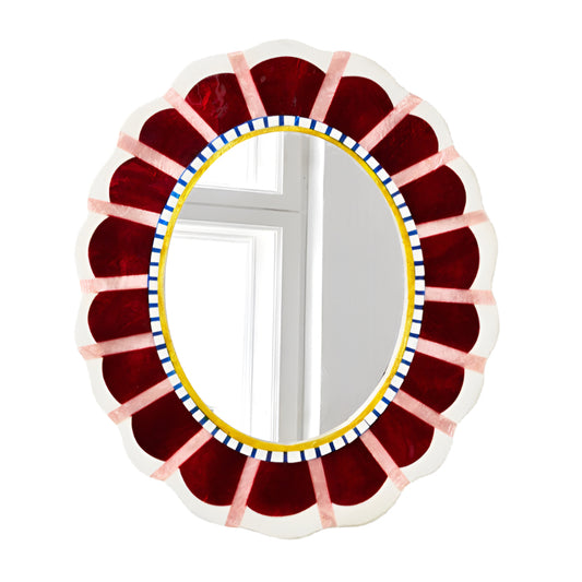 Decorative oval mirror with a colorful circular frame