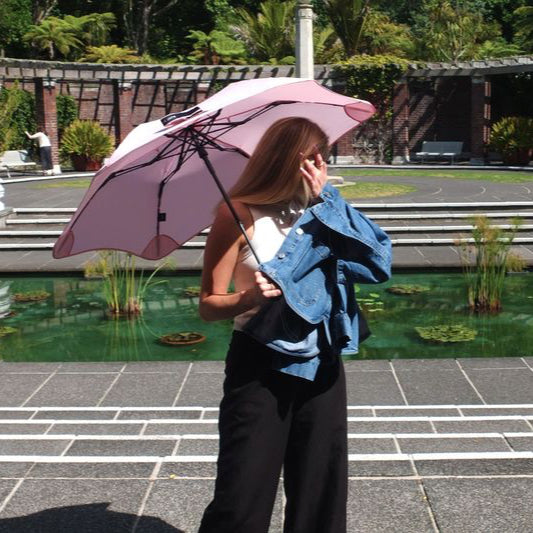 Person holding a pink umbrella