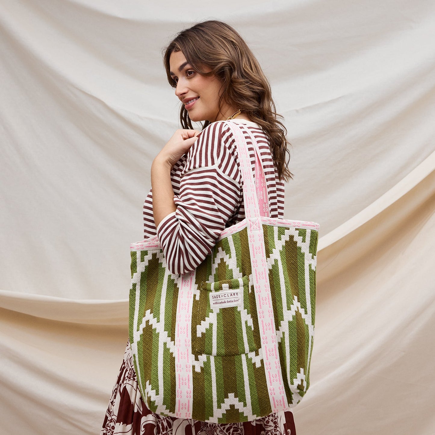 Woman wearing Nisha Palm Woven Tote Bag